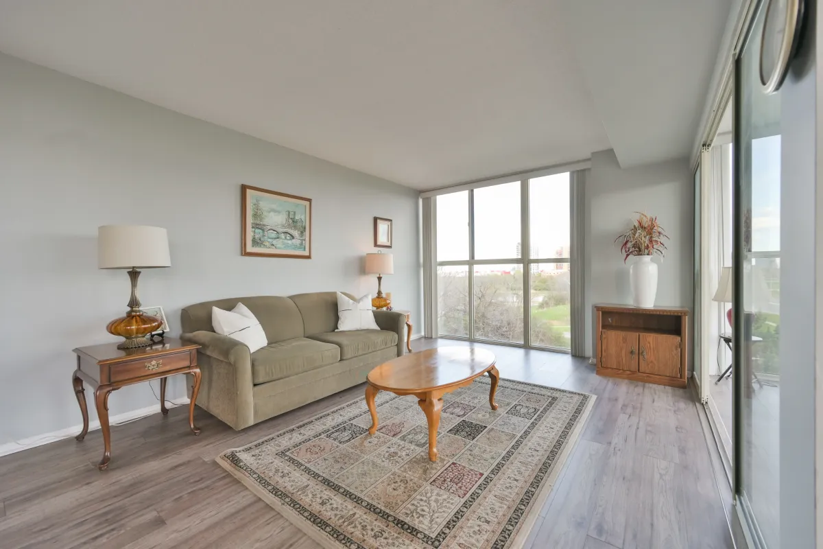 Large living room layout with neutral decor and natural light.