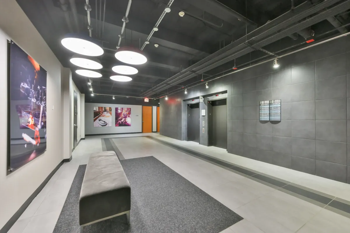Modern elevator bank and hallway corridor in the lobby of 61843 Hanna Ave.