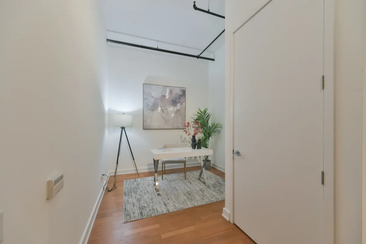 Contemporary bathroom featuring a large mirror and clean stone vanity countertop at 61843 Hanna Ave.