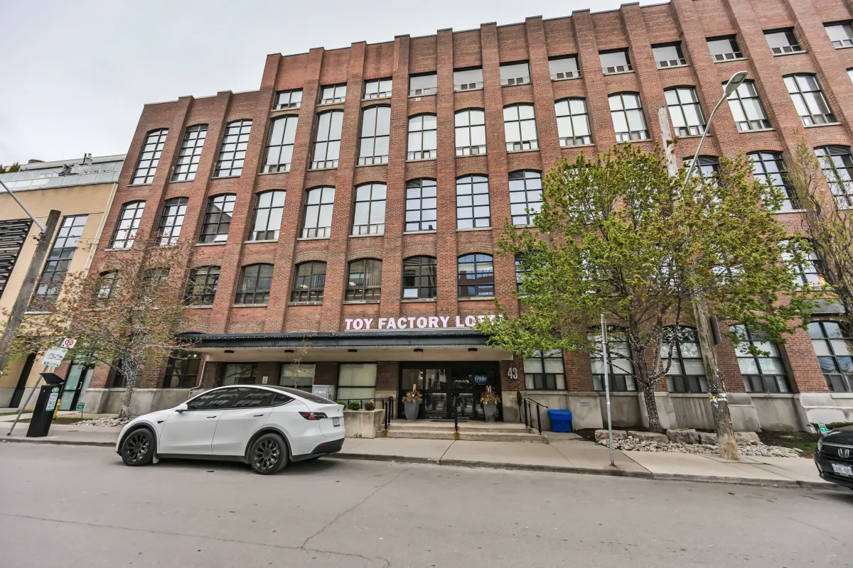 Low-angle view of the brick exterior facade of the Toy Factory Lofts at 61843 Hanna Ave.