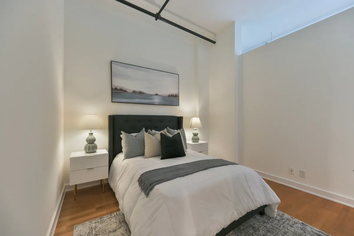 Primary loft bedroom featuring high ceilings and exposed industrial beams at 61843 Hanna Ave.