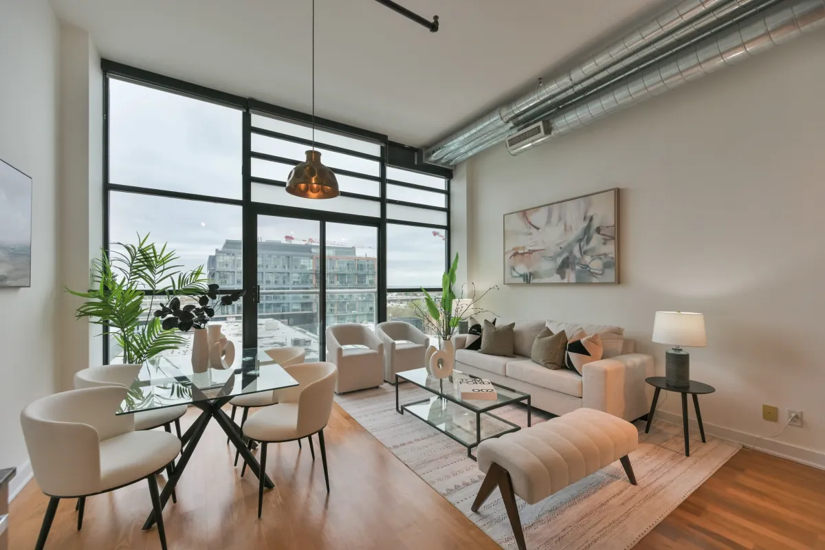 Cozy modern living room arrangement next to large industrial-style windows at 61843 Hanna Ave.