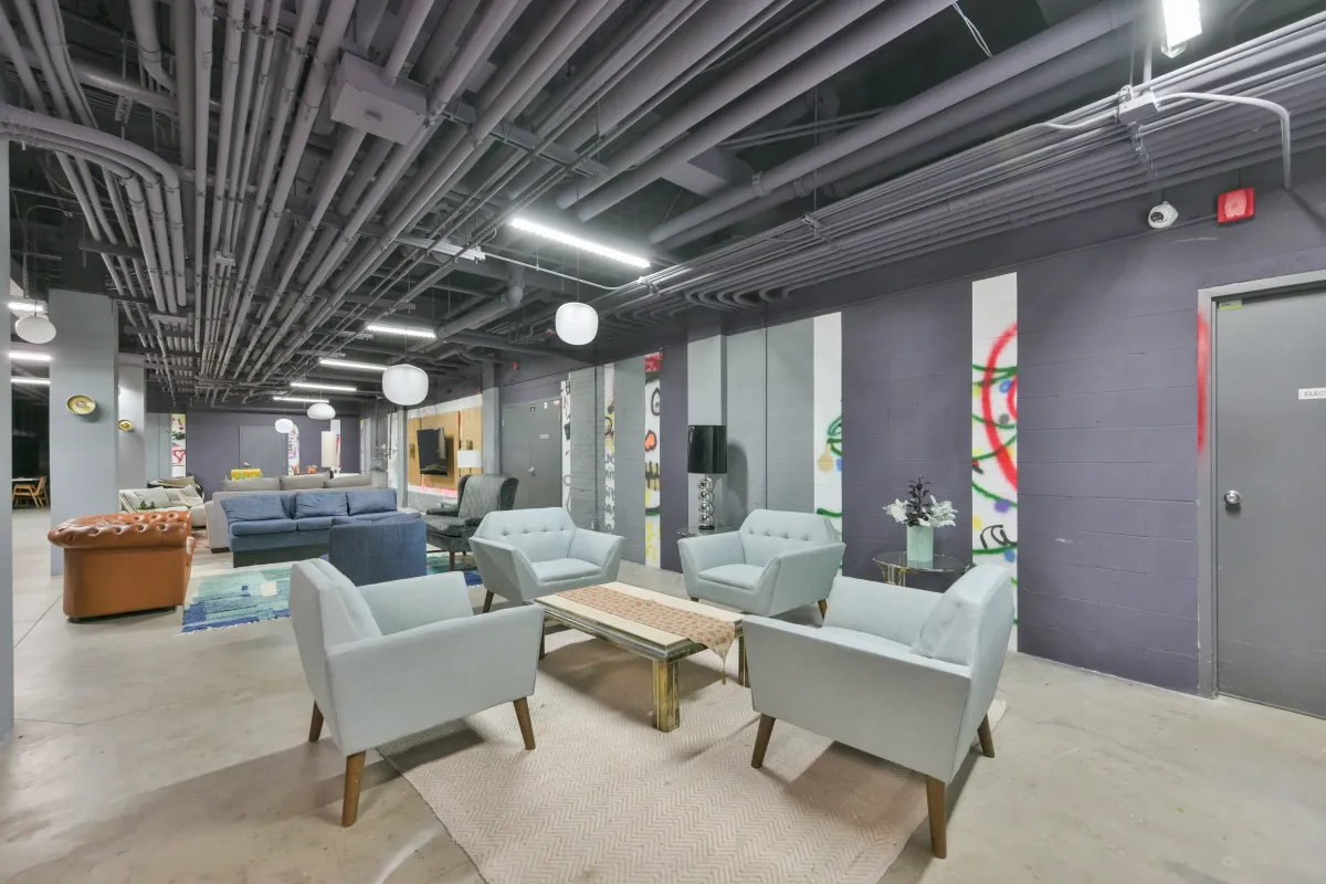 Large entertainment amenity room with seating and media center at 61843 Hanna Ave.