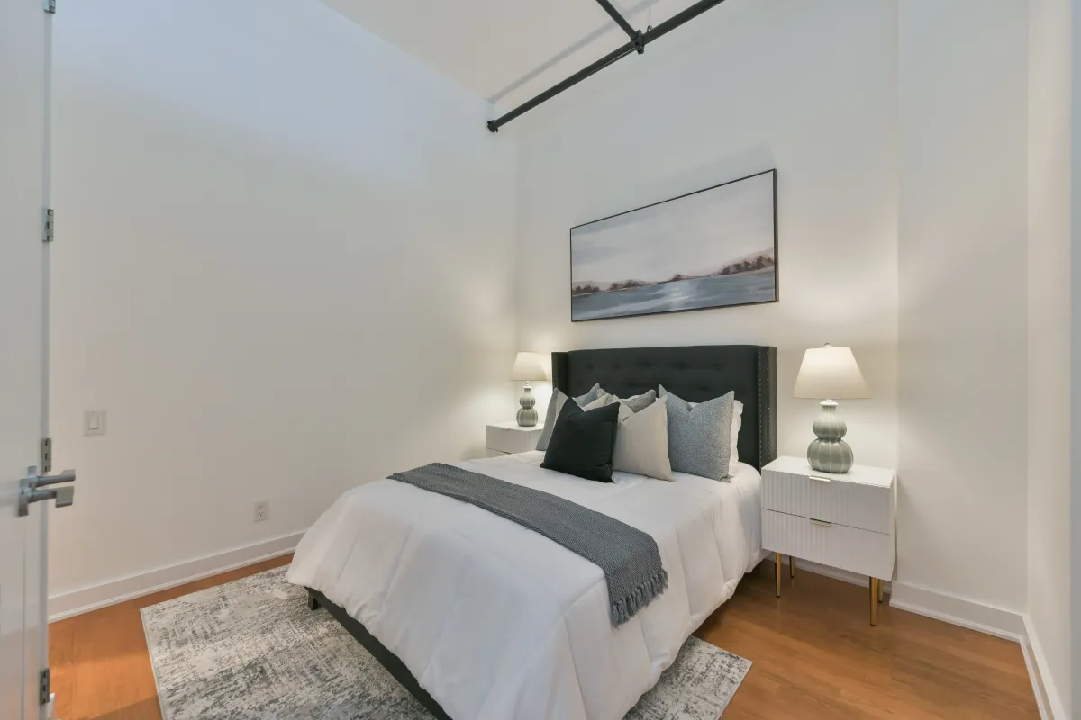 Minimalist bedroom interior showing clean white walls and closet doors at 61843 Hanna Ave.
