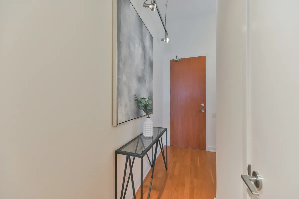 Interior entrance foyer of the loft unit featuring hardwood floors at 61843 Hanna Ave.