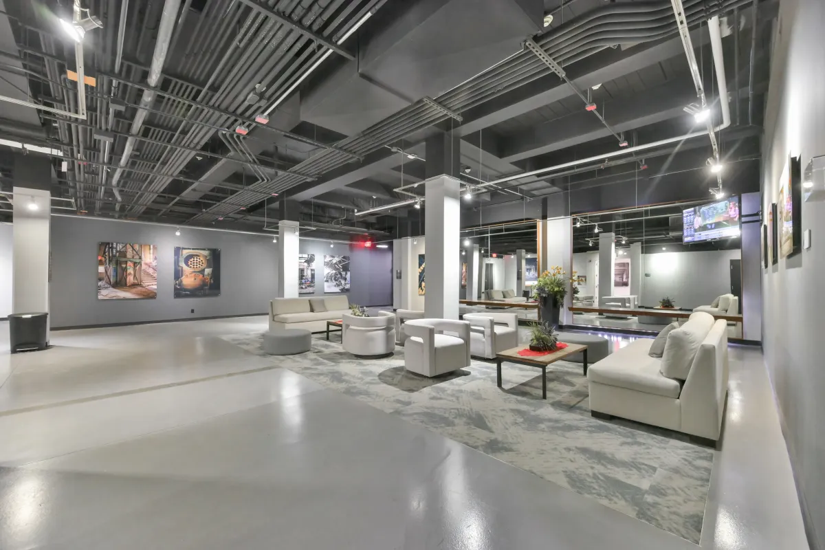 Spacious main lobby lounge with modern seating and industrial ceilings at 61843 Hanna Ave.