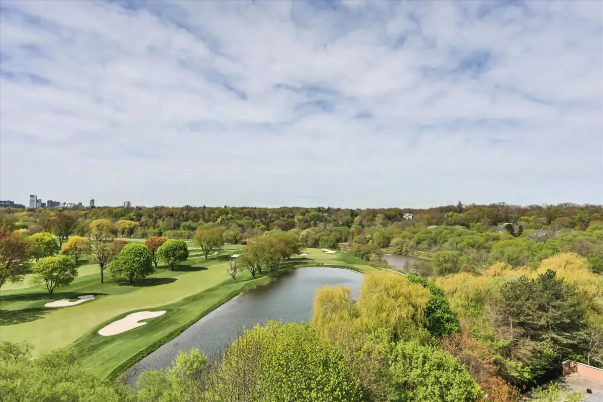Panoramic parkland and golf course vistas under a blue sky, captured from the high-floor vantage point of 240 Scarlett Rd #912.