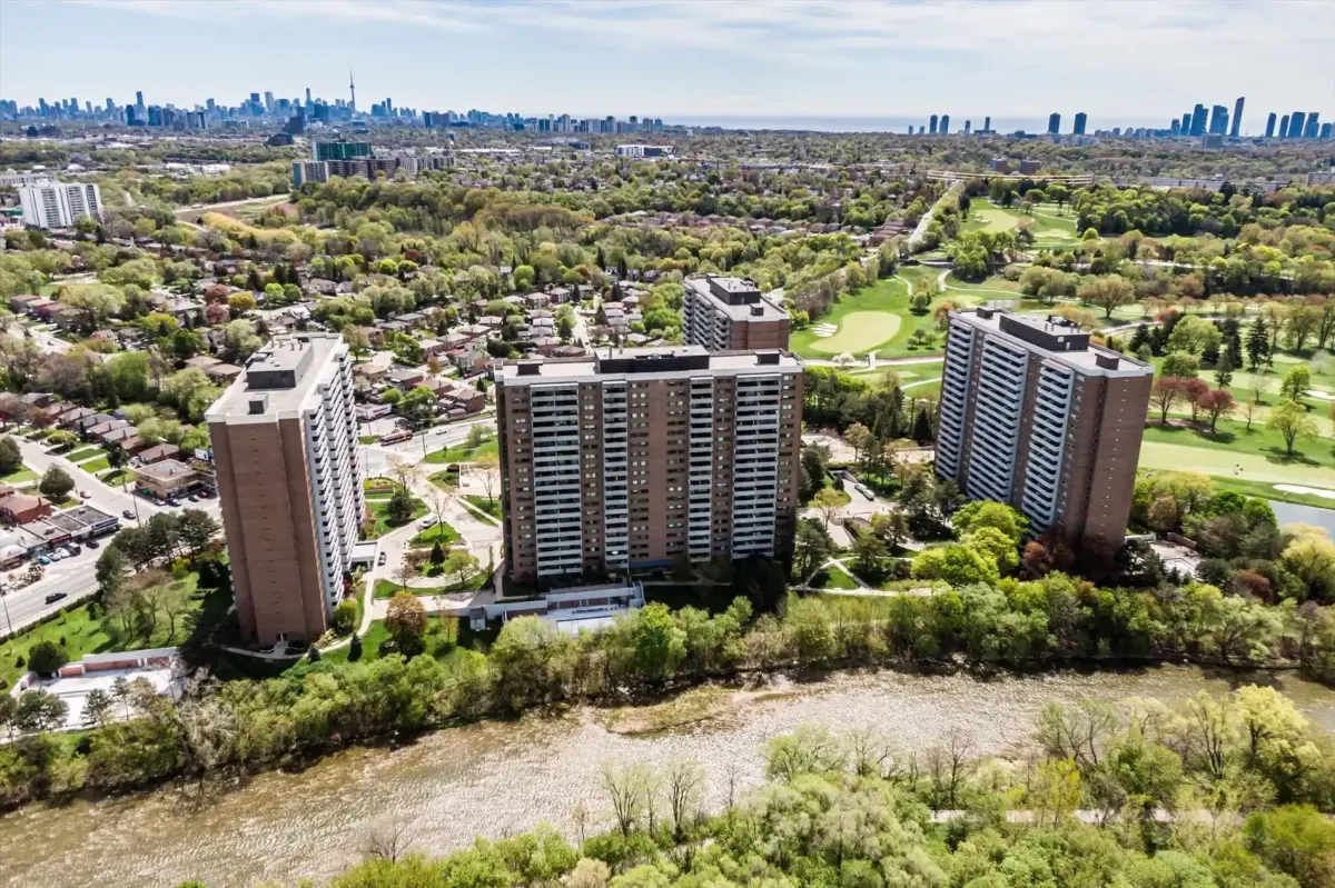 High-angle aerial view of the condo building complex at 240 Scarlett Rd #912, showcasing the green parklands and cityscape in the background.