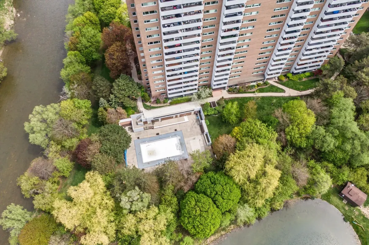 High aerial view looking down at the outdoor swimming pool facility and landscaped walking paths at 240 Scarlett Rd #912.