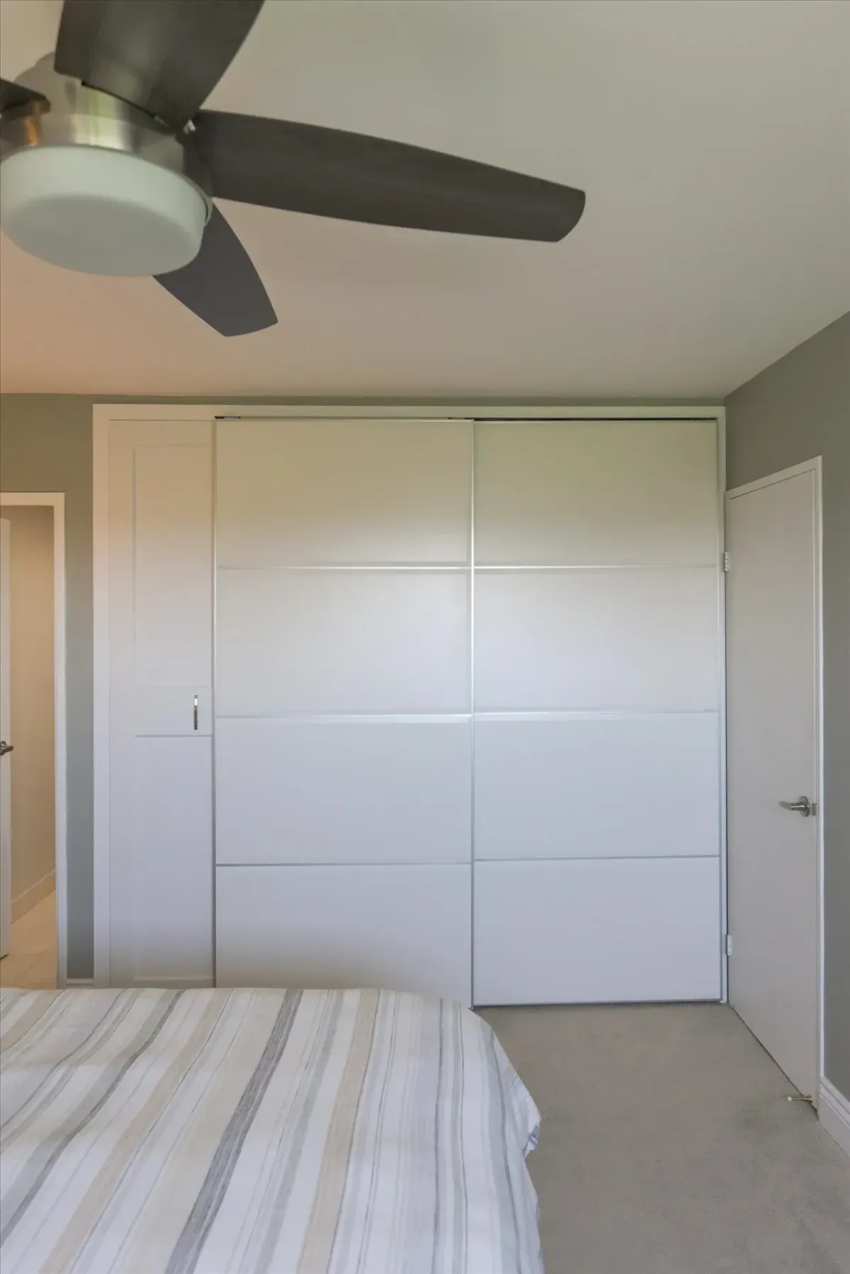 Close-up of the ceiling fan and integrated custom sliding wardrobe doors in the primary bedroom of 240 Scarlett Rd #912.