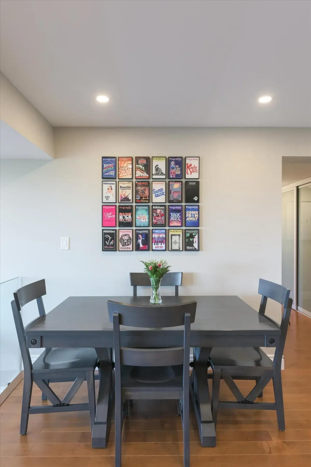 Feature wall with custom artwork framing in the open-concept dining room area of 240 Scarlett Rd #912.