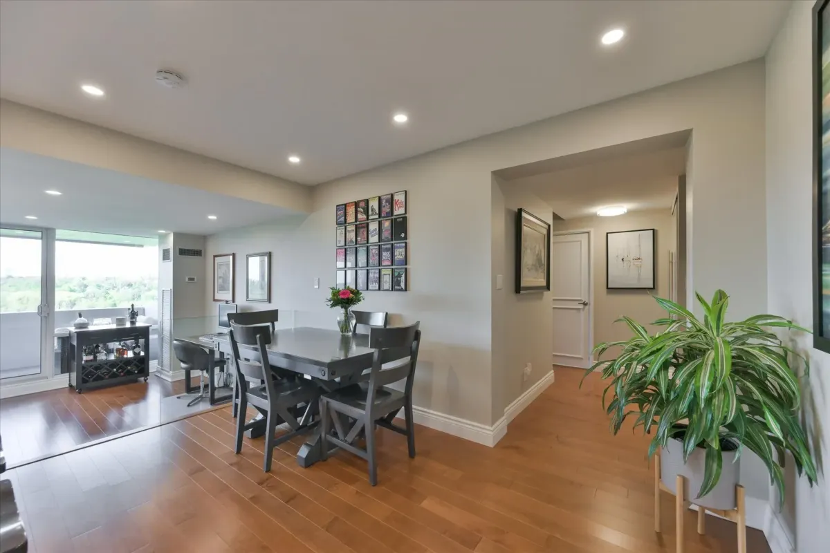 Open-concept dining space looking towards the residential entryway and hallway inside 240 Scarlett Rd #912.