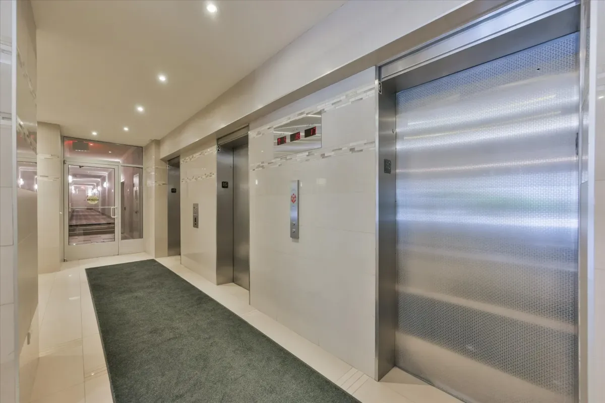 Clean and well-lit elevator bank hallway inside the main lobby of 240 Scarlett Rd #912.