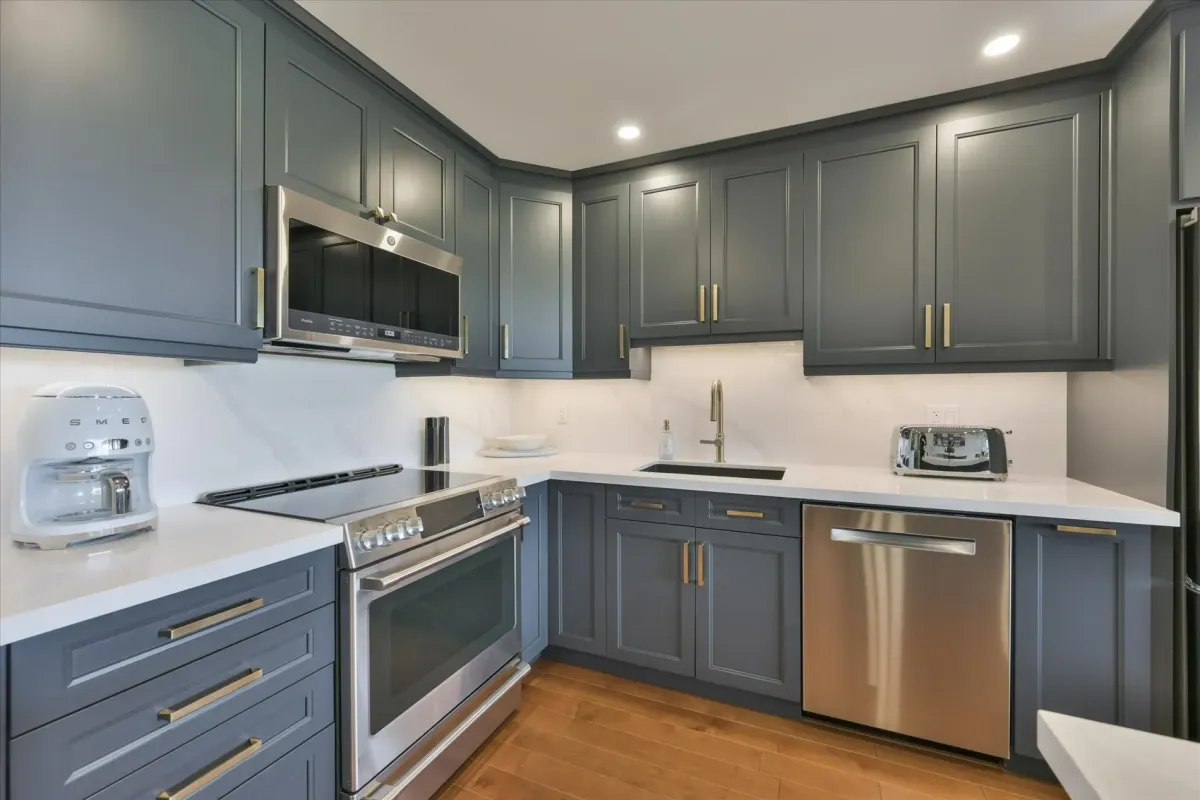 Close-up of the grey shaker kitchen cabinets, white tiled backsplash, and under-cabinet lighting at 240 Scarlett Rd #912.