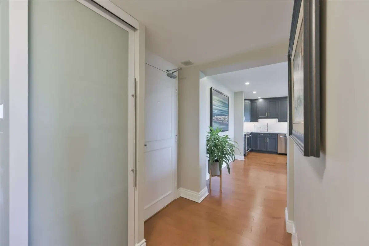 Bright hallway inside 240 Scarlett Rd #912 transitioning into an open-concept kitchen space.