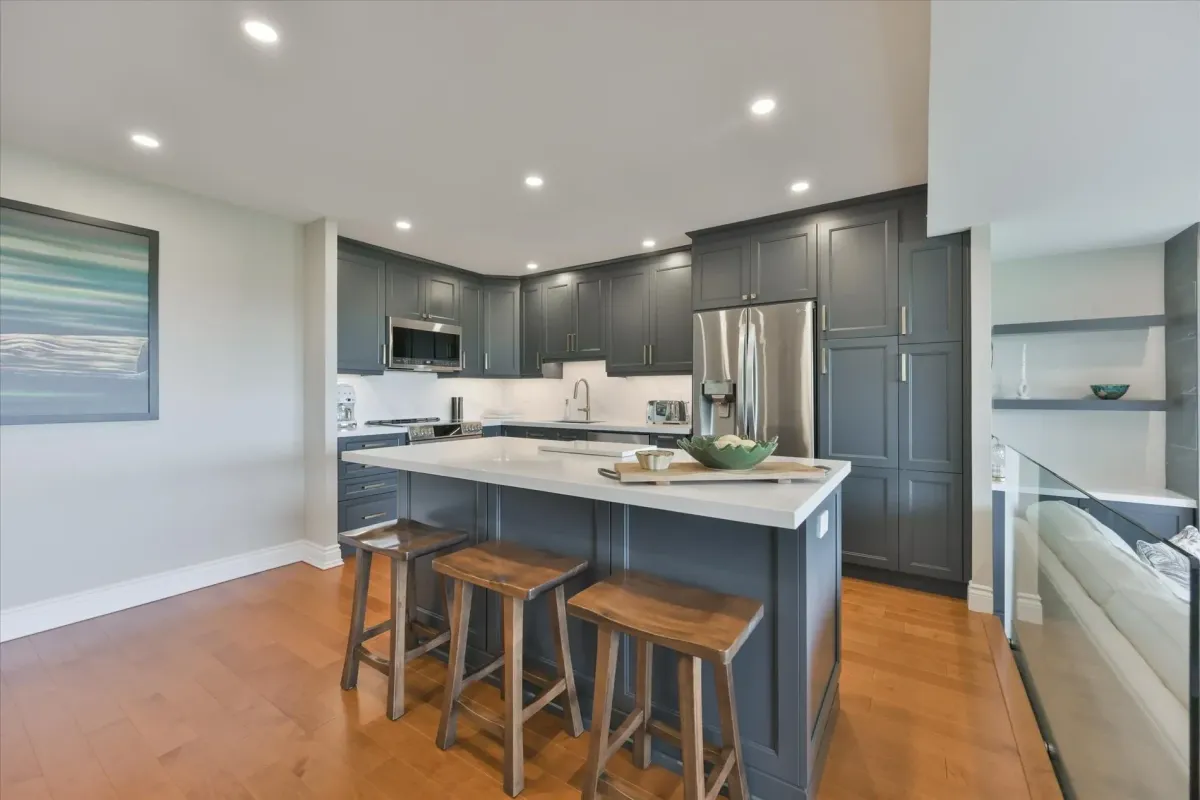 Kitchen island breakfast bar with seating and pendant rough-ins over quartz counters at 240 Scarlett Rd #912.