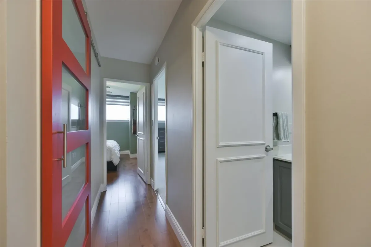 Clean interior corridor inside 240 Scarlett Rd #912 showing crisp white doors, molding details, and wood flooring.