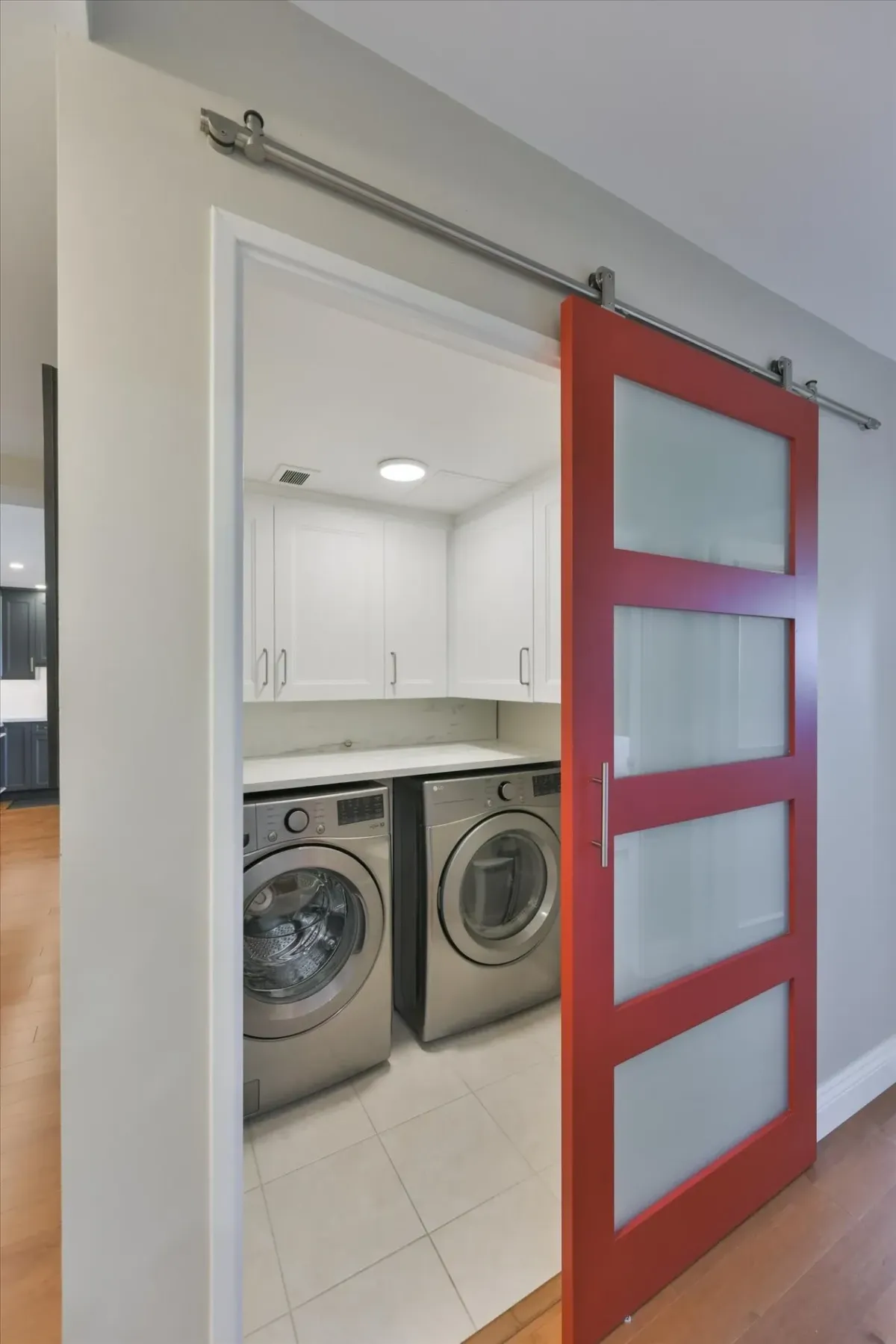 Dedicated laundry room entrance at 240 Scarlett Rd #912 featuring a stylish red sliding barn door.