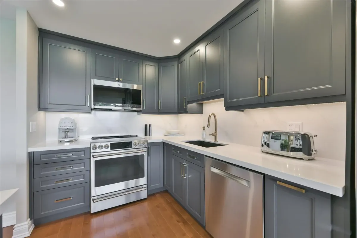 Corner view of the modern kitchen layout at 240 Scarlett Rd #912 highlighting the stainless steel gas stove, microwave, and dishwasher.