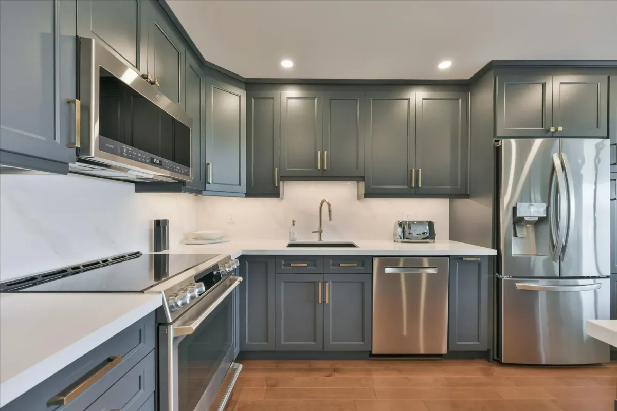 Clean linear view of the modern grey cabinetry, quartz countertops, and under-mount sink at 240 Scarlett Rd #912.