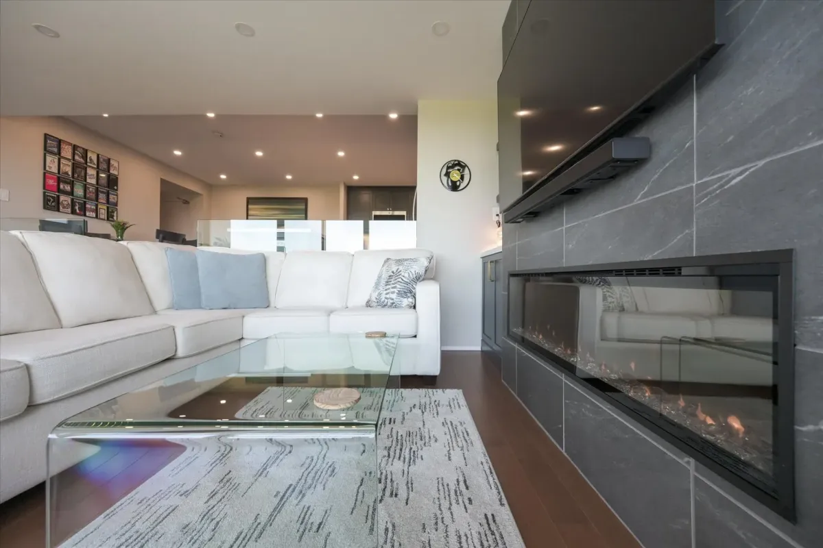 Living room seating arrangement with a glass coffee table highlighting the open-concept flow at 240 Scarlett Rd #912.