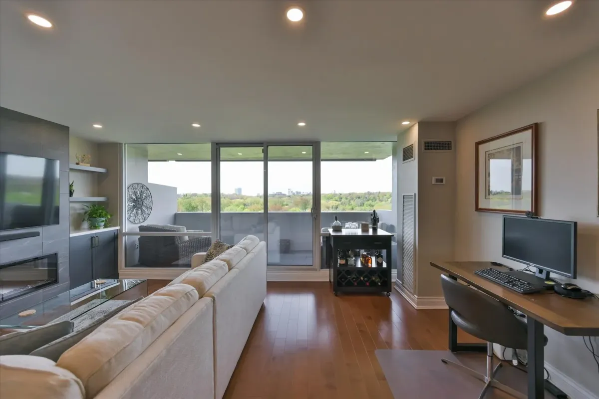 Bright living room space at 240 Scarlett Rd #912 with large sliding glass doors leading to a private balcony.