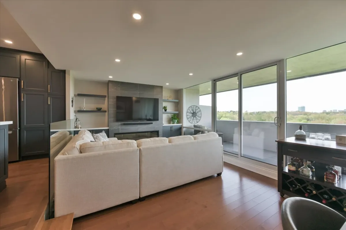Comfortable open living room layout at 240 Scarlett Rd #912 showcasing a large neutral sectional sofa and floor-to-ceiling windows.