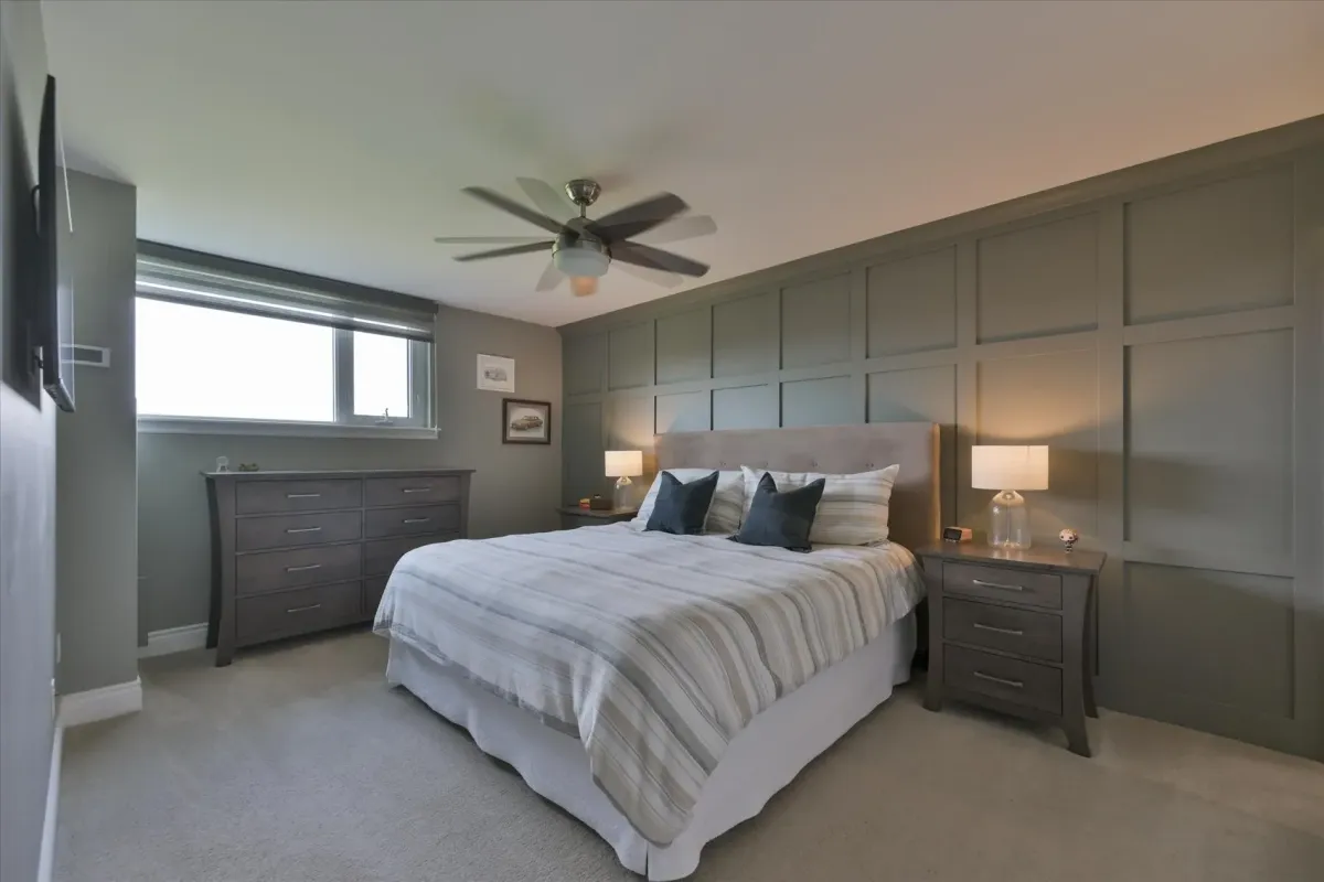 Large primary bedroom suite at 240 Scarlett Rd #912 featuring an accent wall, window, and ceiling fan.
