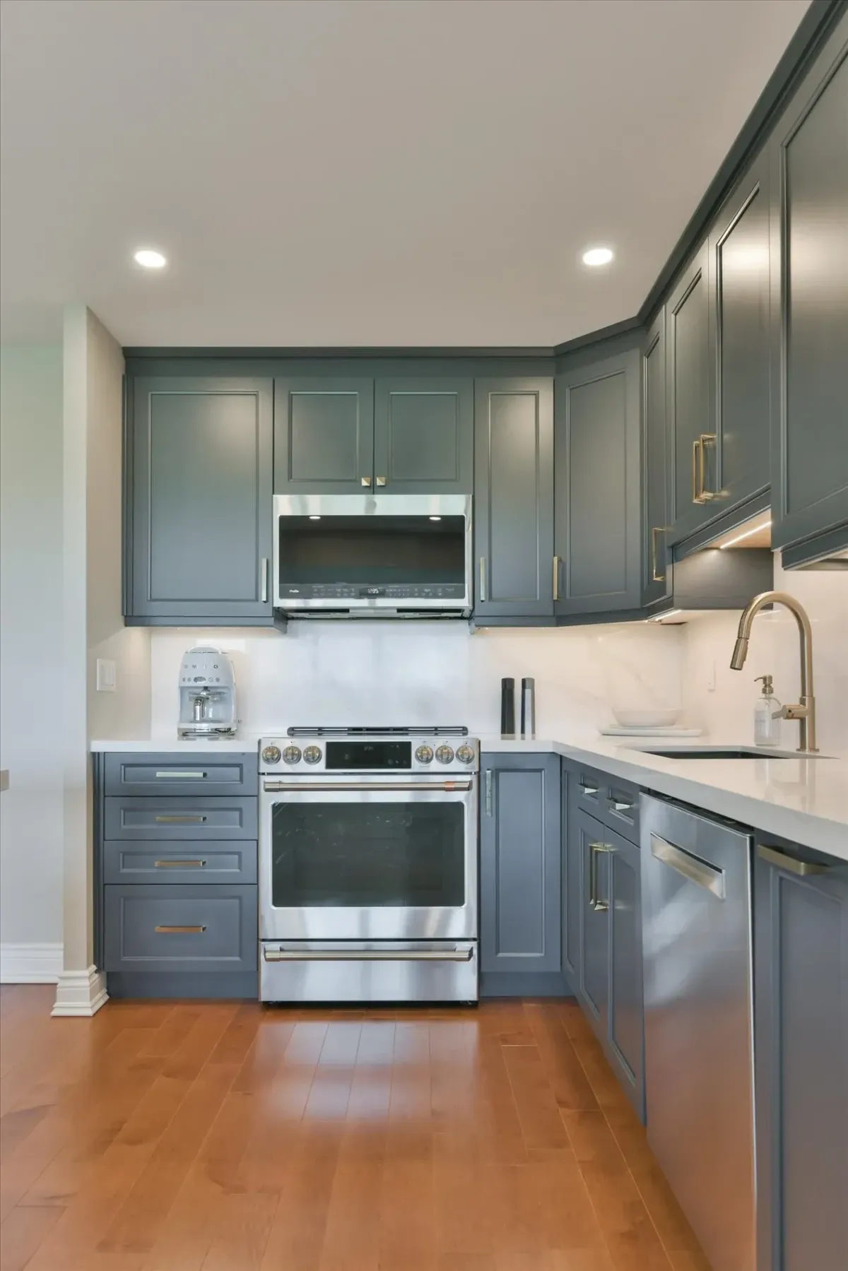 Sleek stainless steel stove and range hood microwave setup surrounded by modern cabinets at 240 Scarlett Rd #912.
