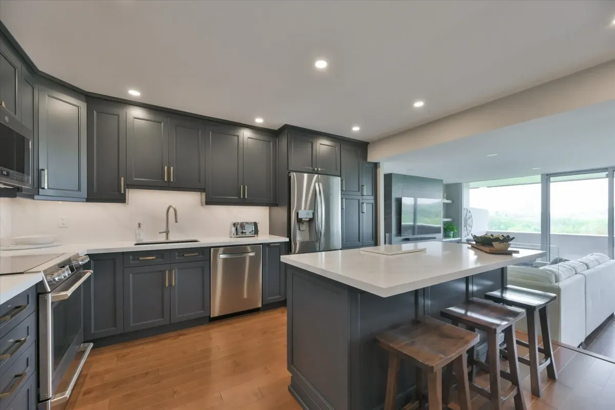 Fully renovated kitchen at 240 Scarlett Rd #912 featuring a central island, grey cabinetry, and stainless steel appliances.