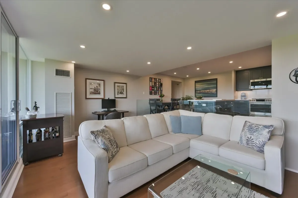 Wide-angle view of the large L-shaped sectional sofa in the main open living environment of 240 Scarlett Rd #912.