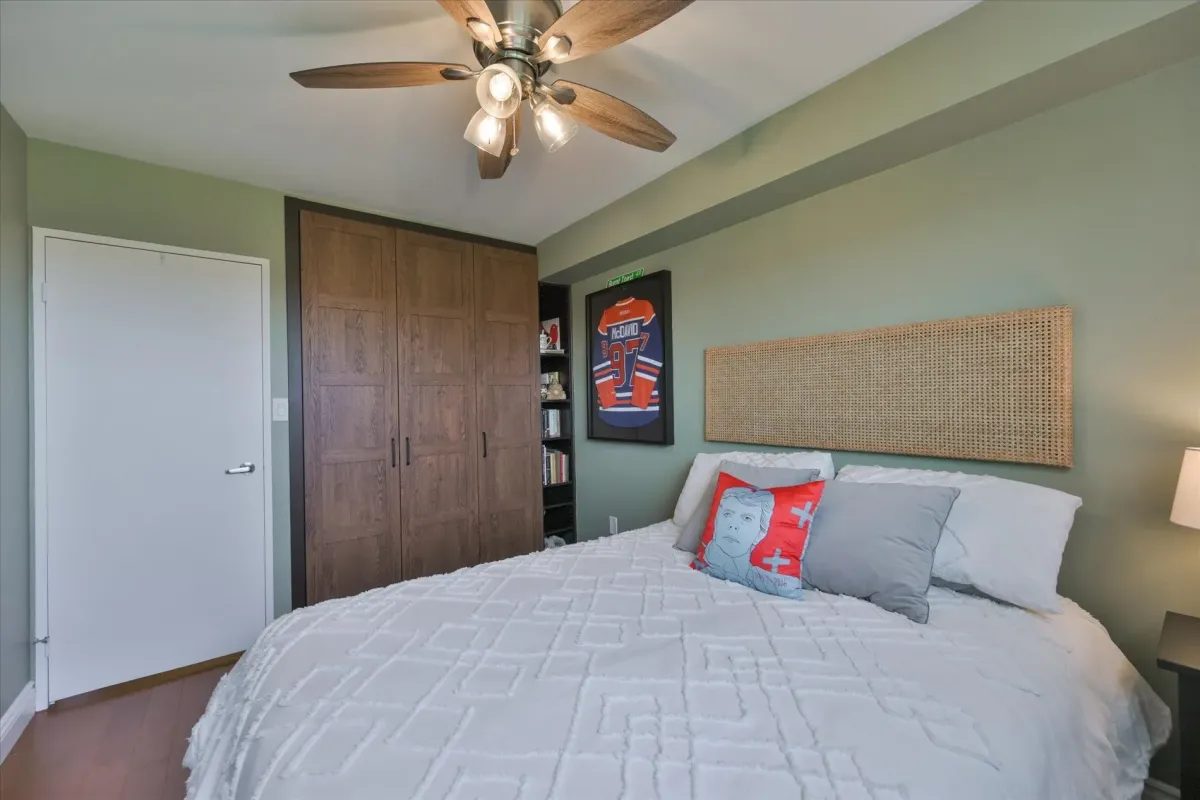 Alternate view of the second bedroom at 240 Scarlett Rd #912 highlighting a woven headboard and built-in closet storage.