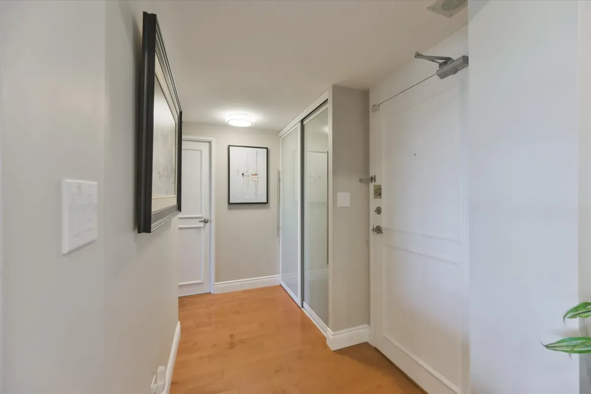 Interior foyer and entryway of unit 240 Scarlett Rd #912 featuring wood flooring and a closet.