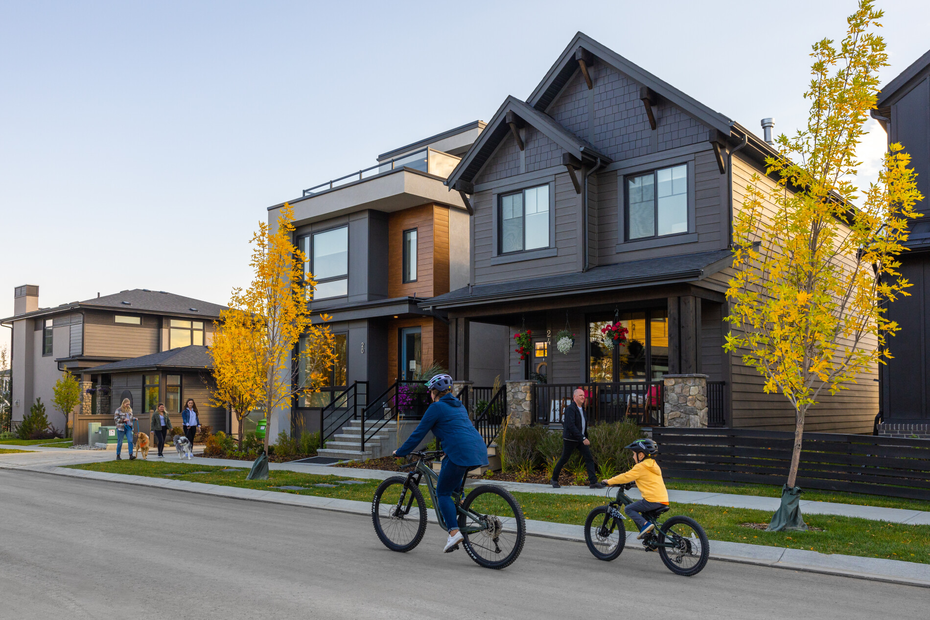15020 Bow Trail SW Alpine Park Calgary family riding bicycles past modern porch front detached residential homes