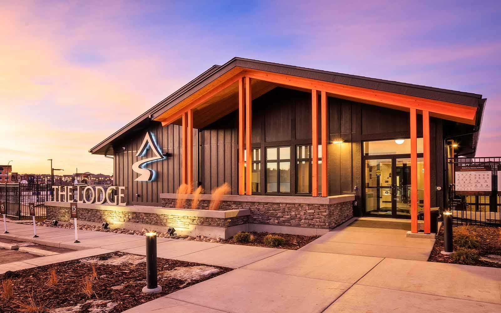 Rockland Park NW Calgary The Lodge community center building exterior with modern architectural lighting.
