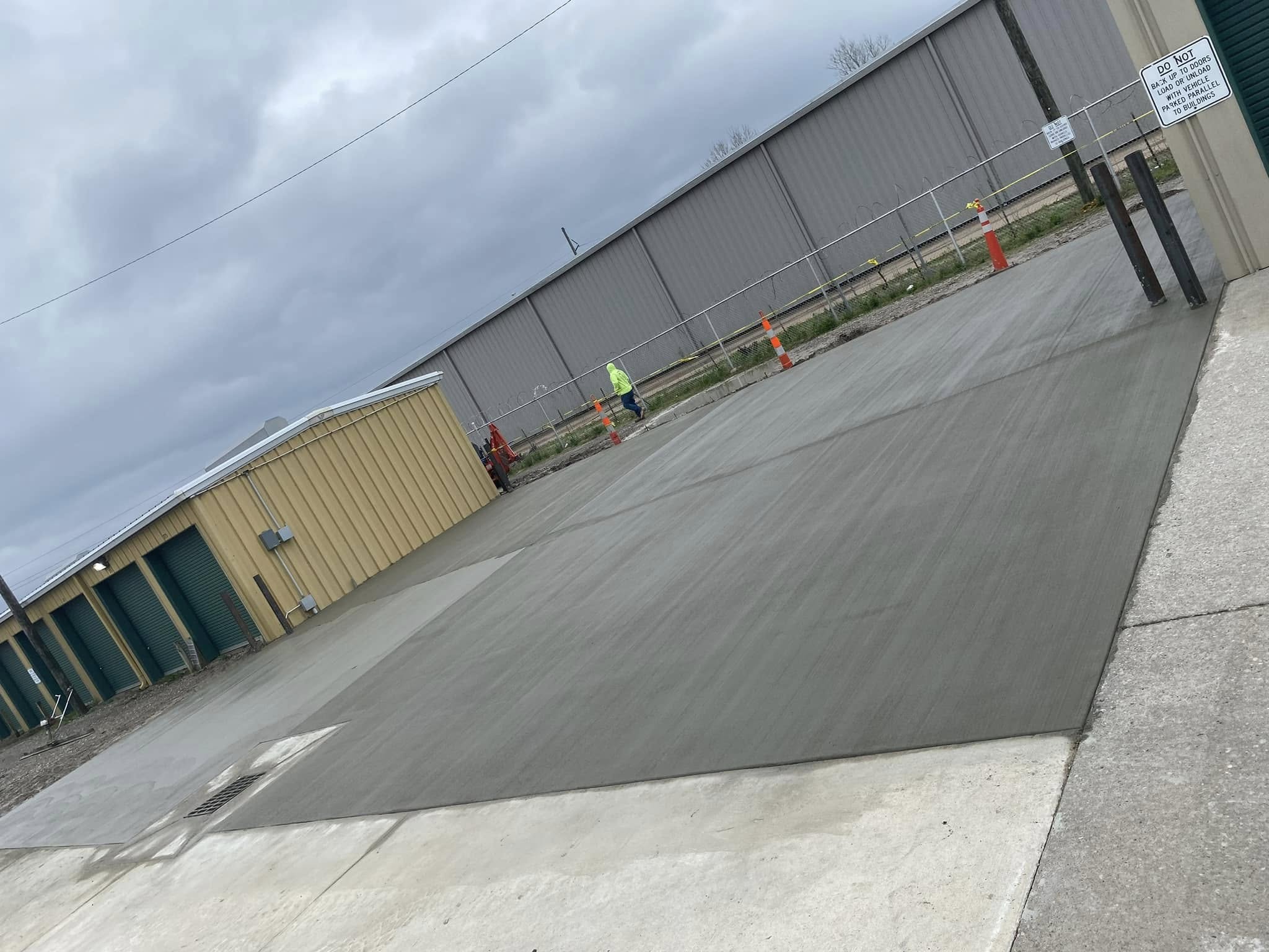man kneeling on unfinished building during daytime