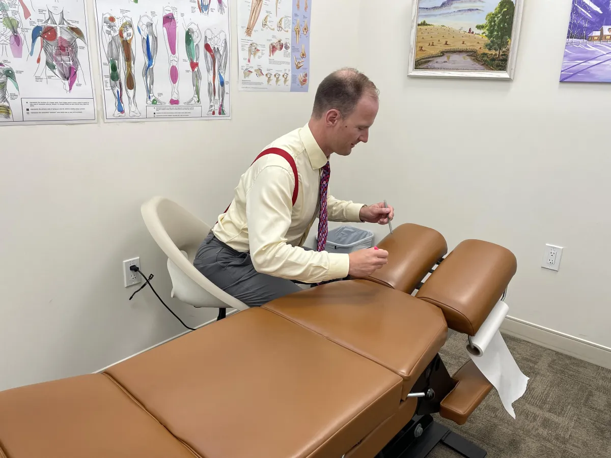 Chiropractor performing spinal adjustment on patient in Regina clinic