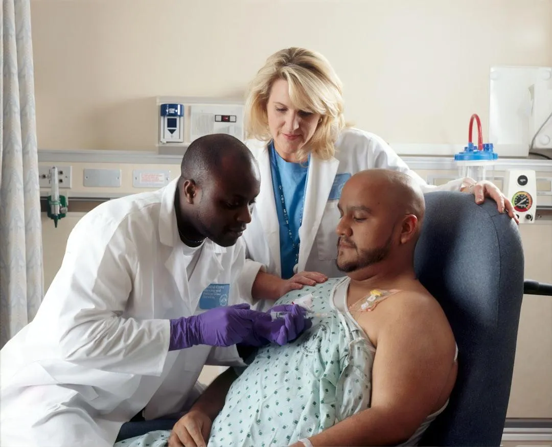 Man in a hospital receiving chemotherapy treatment, highlighting the importance of income protection and critical illness coverage for financial stability during medical crises.