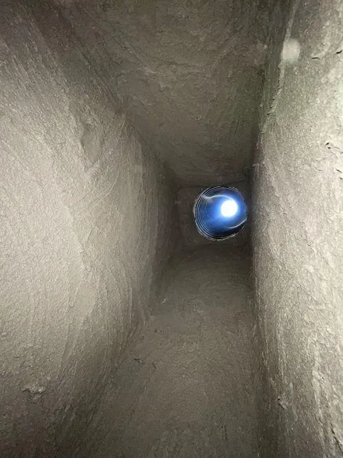 View of stainless steel relining installed in a chimney from below