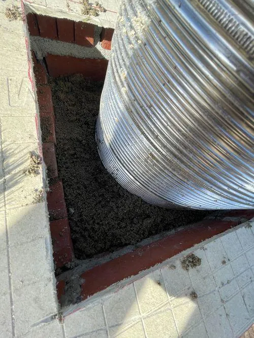 View of stainless steel relining installed in a chimney from above