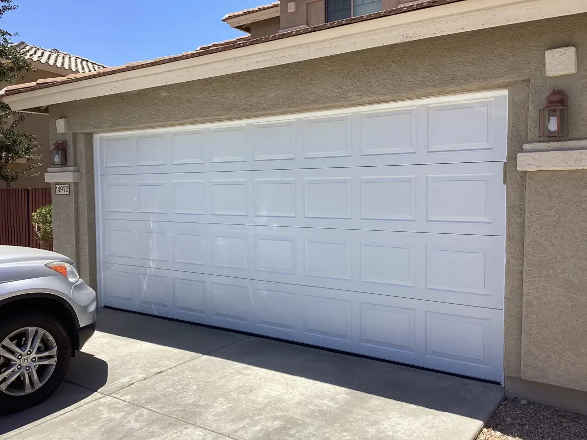 Freshly completed epoxy garage floor coating with a smooth, durable finish inside a clean two-car garage.