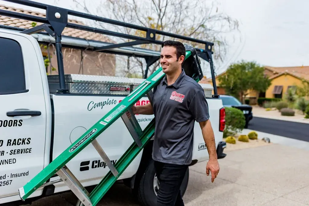 employee holding ladder walking to garage