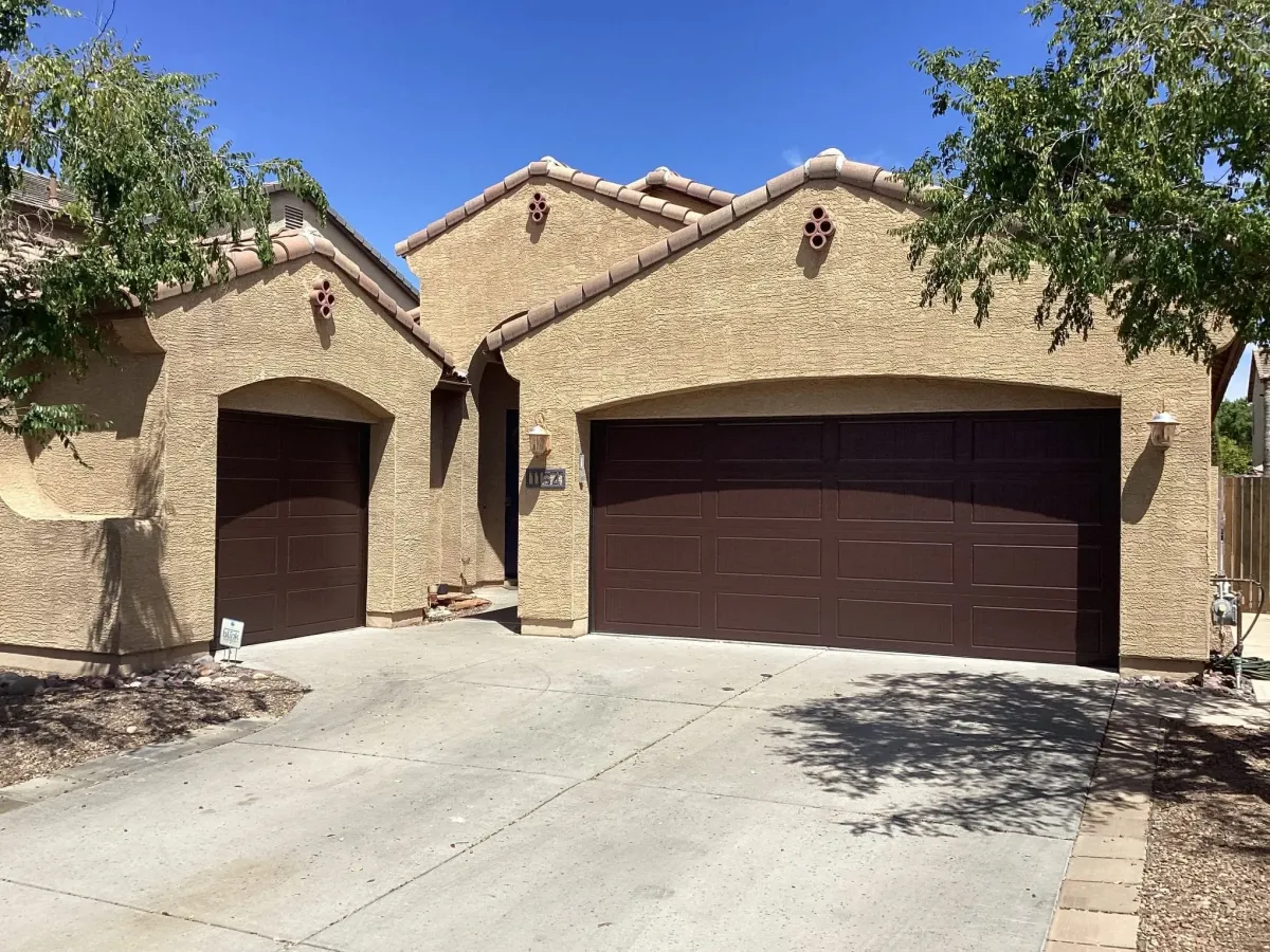 Freshly coated epoxy garage floor reflecting sunlight inside an empty single-car garage.