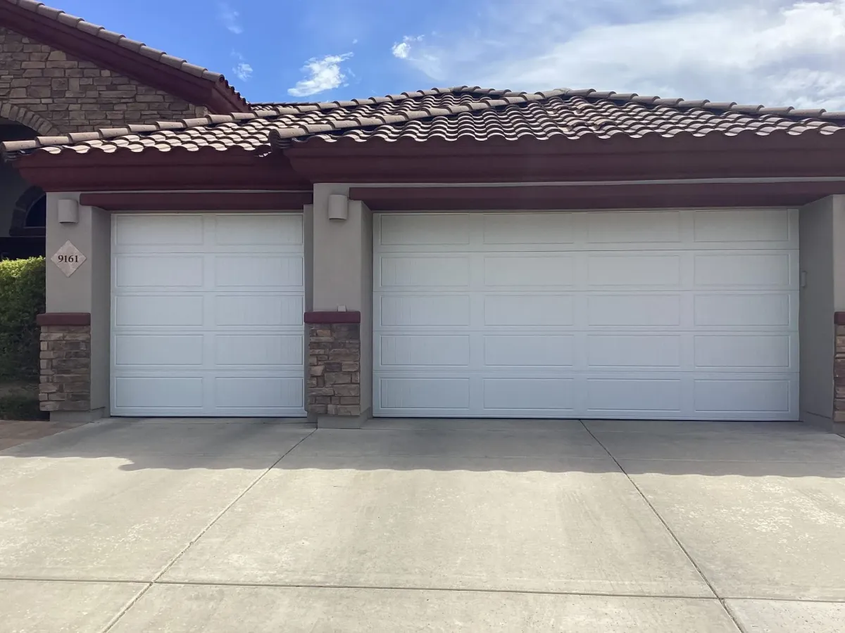 employee holding ladder walking to garage