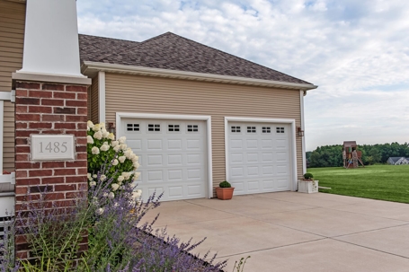 A picture of a house with two garage doors