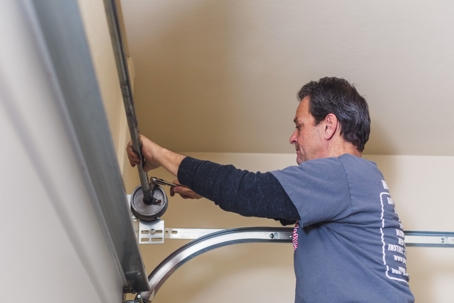 A technician fixing a garage door
