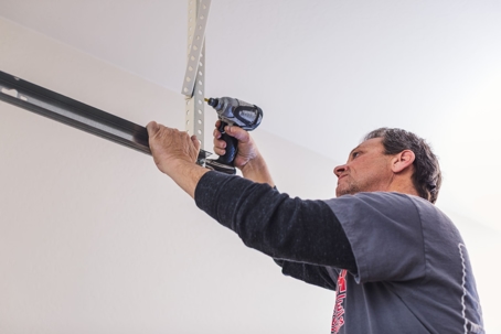 A technician fixing a garage door