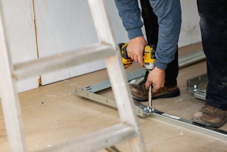 A technician fixing a garage spring door