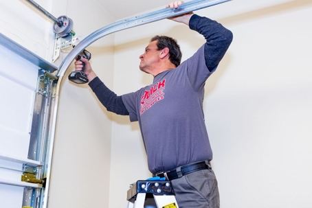 A technician fixing a garage door