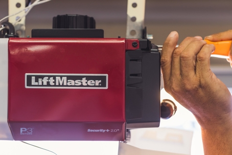 A person is fixing a garage door opener